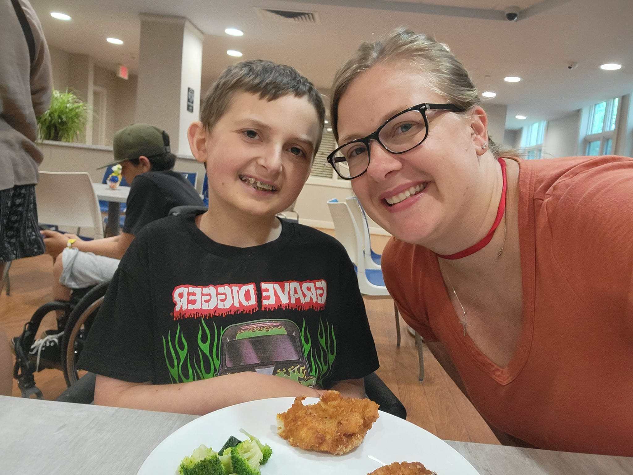 child and adult eating a meal while in care at a local hospital.