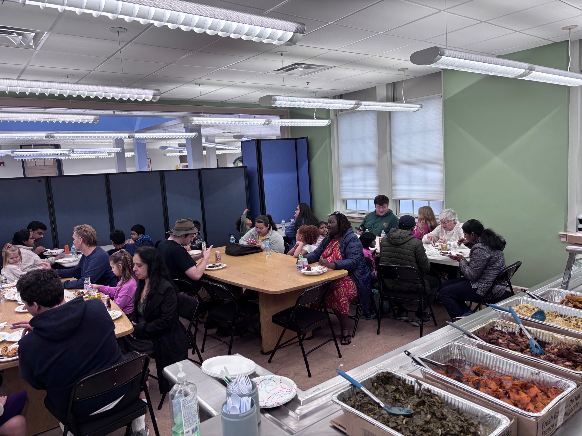 families eating and discussing at a community event