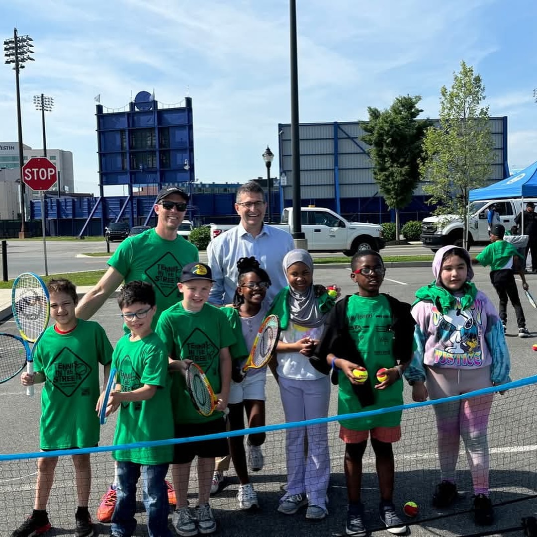 instructors and students posing for tennis drills
