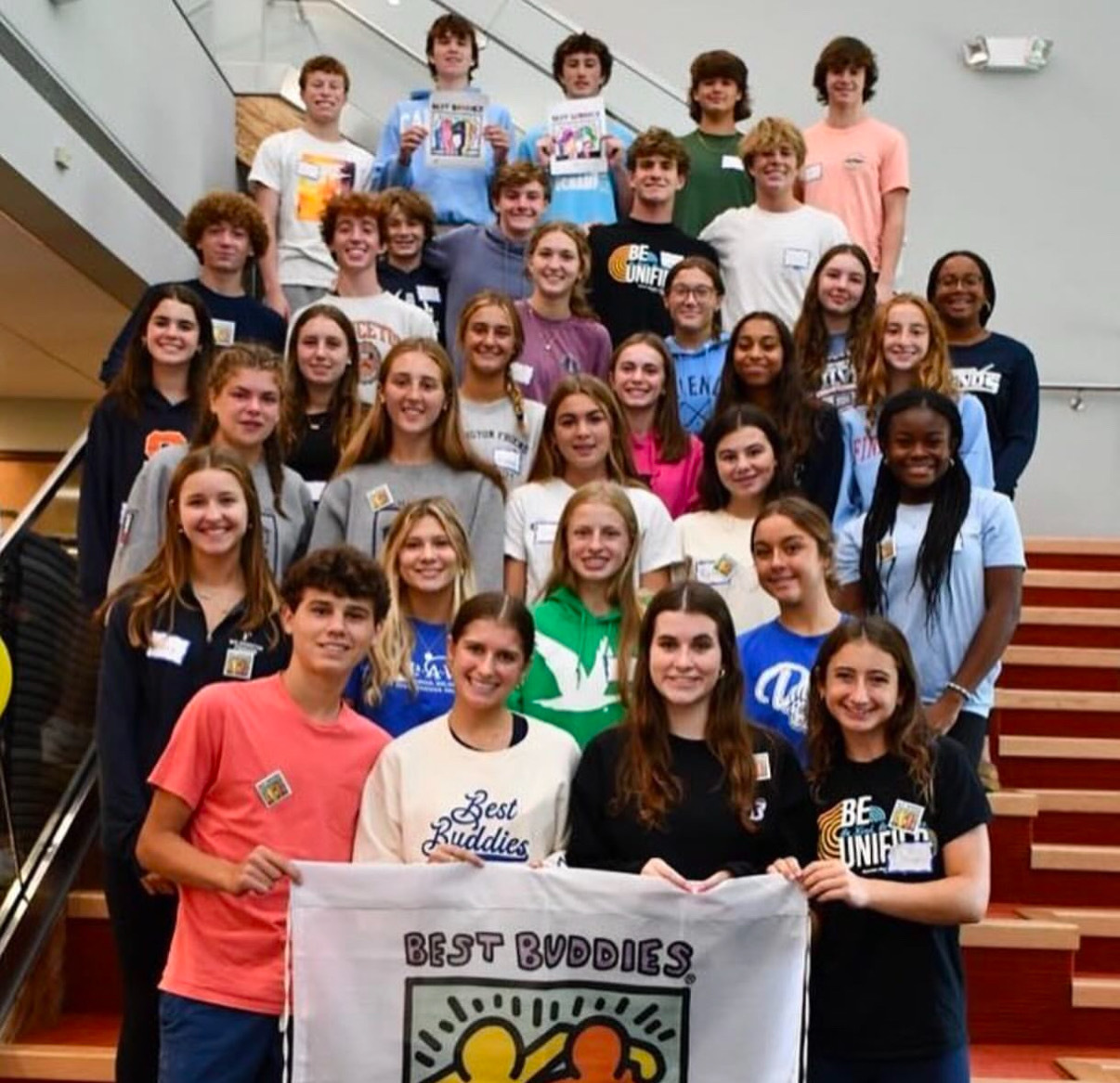 Best Buddies ambassadors posing in front of a hallway