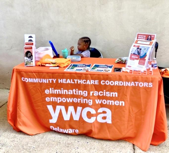 a child sitting at a community health worker table