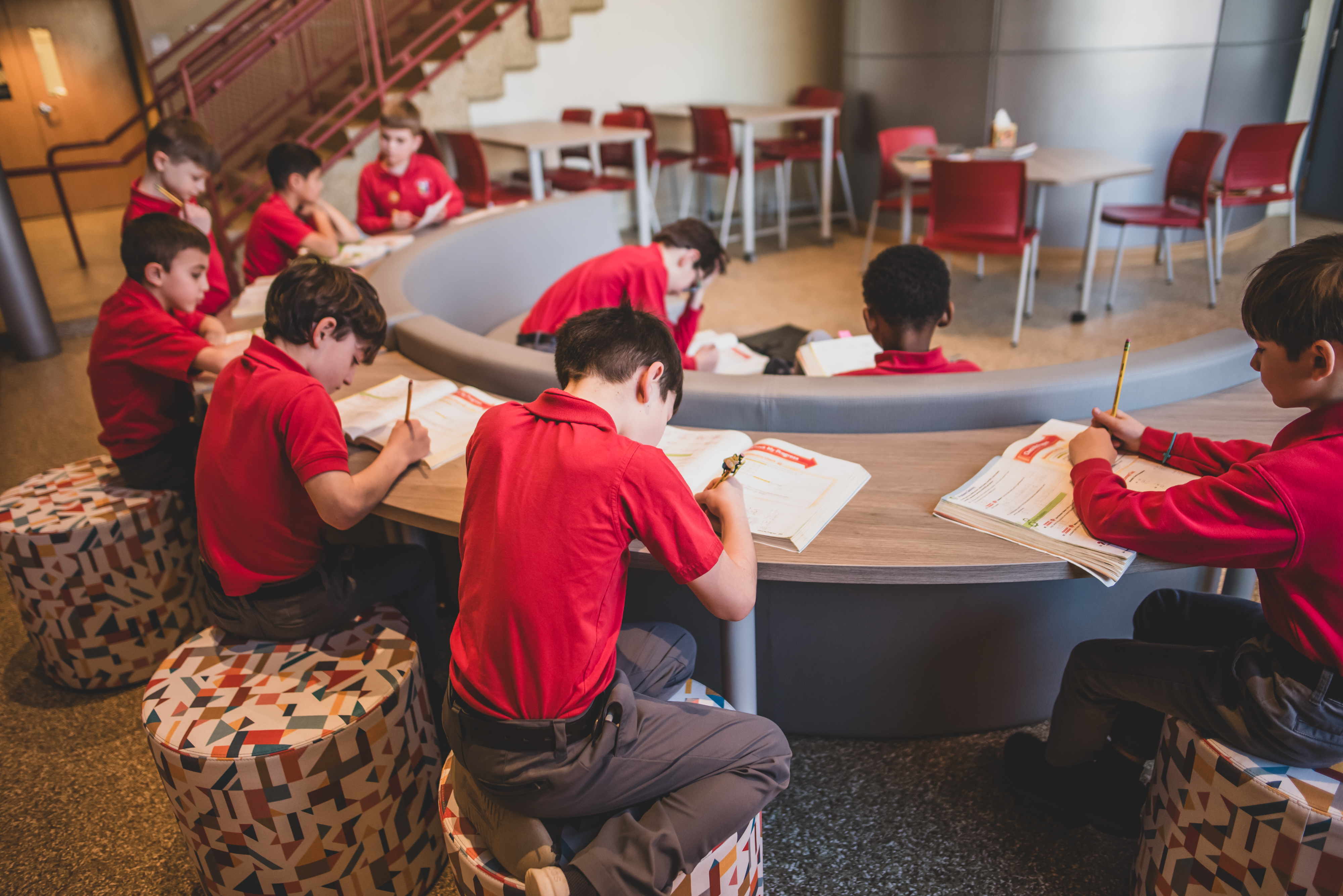 students sitting within a learning area room.