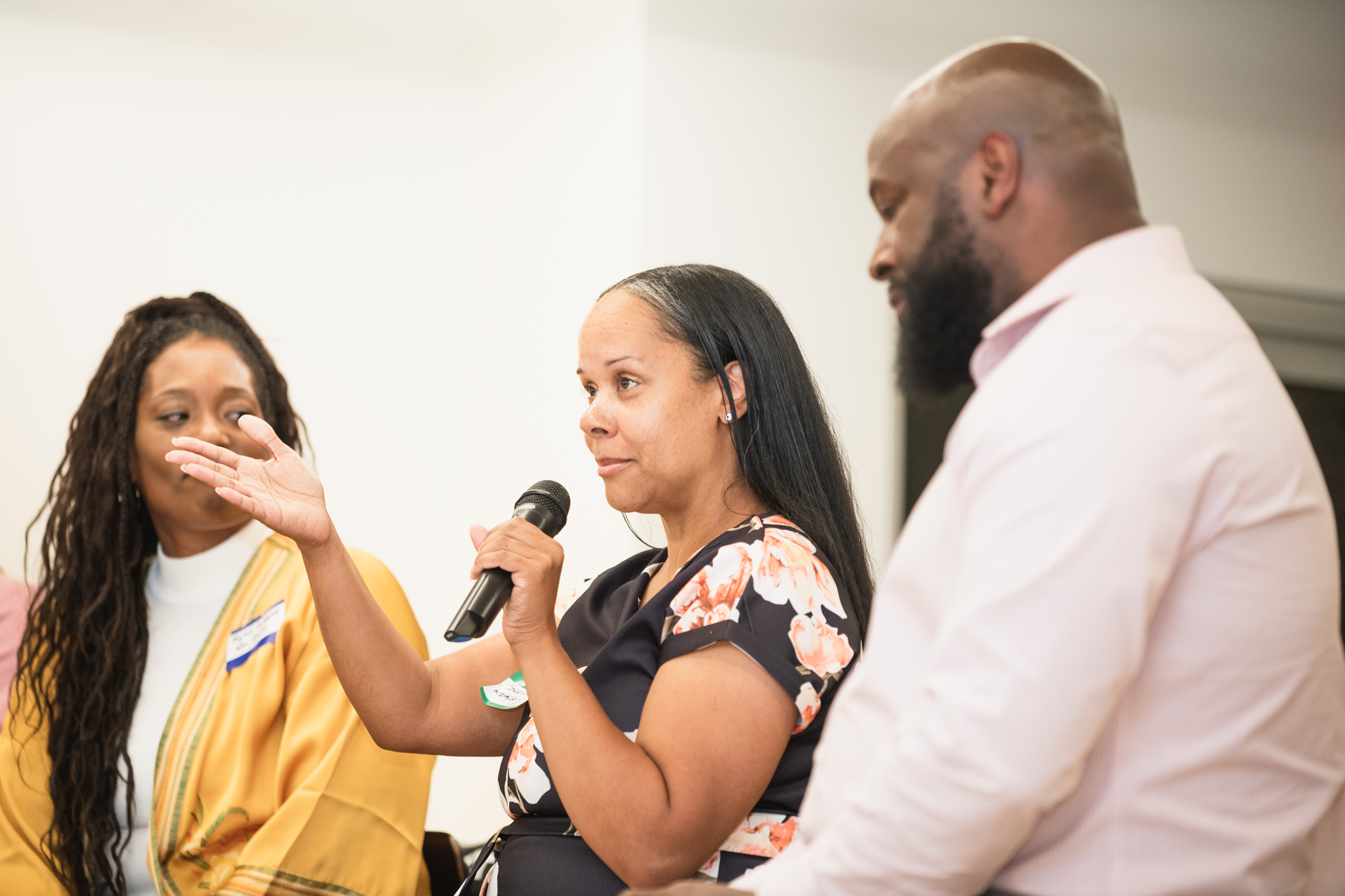 three participants talking on a panel during workshops.