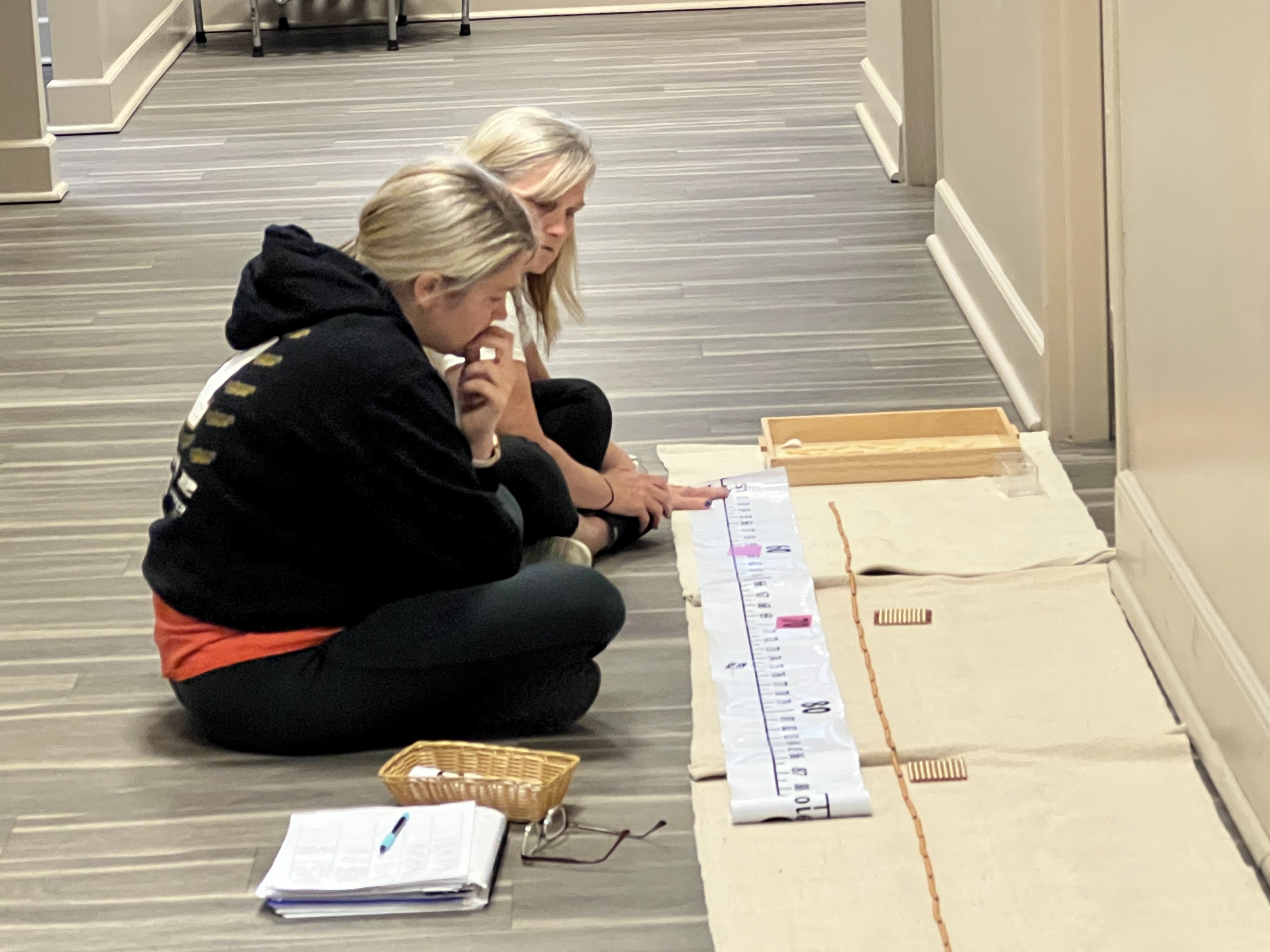 educators preparing for a school year while sitting on a floor.
