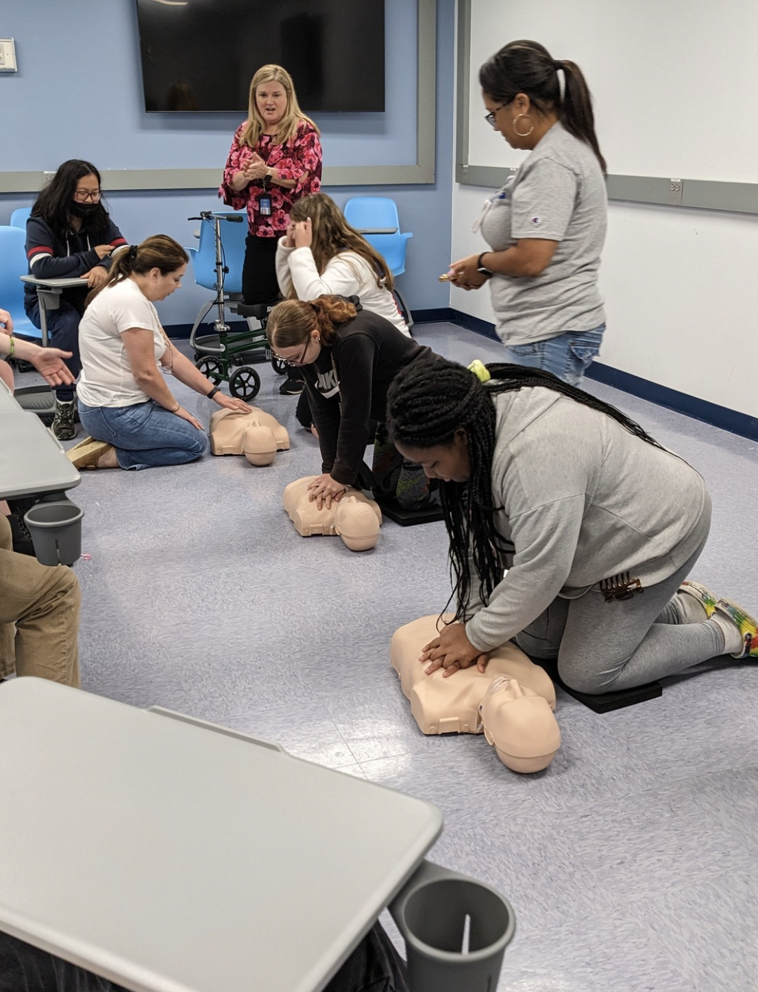 students performing CPR training in a learning lab.