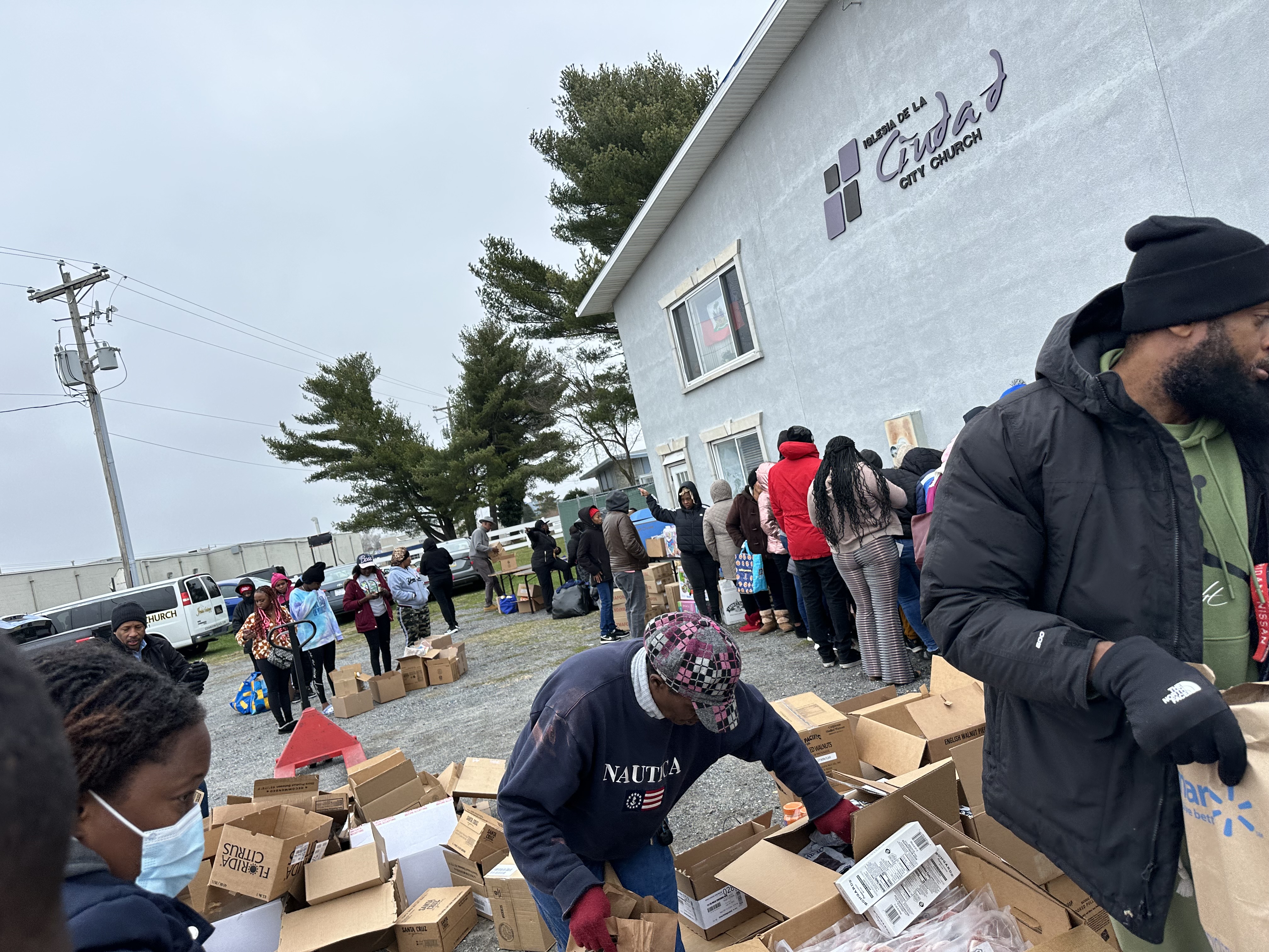 volunteers assist in preparing boxes of donation items