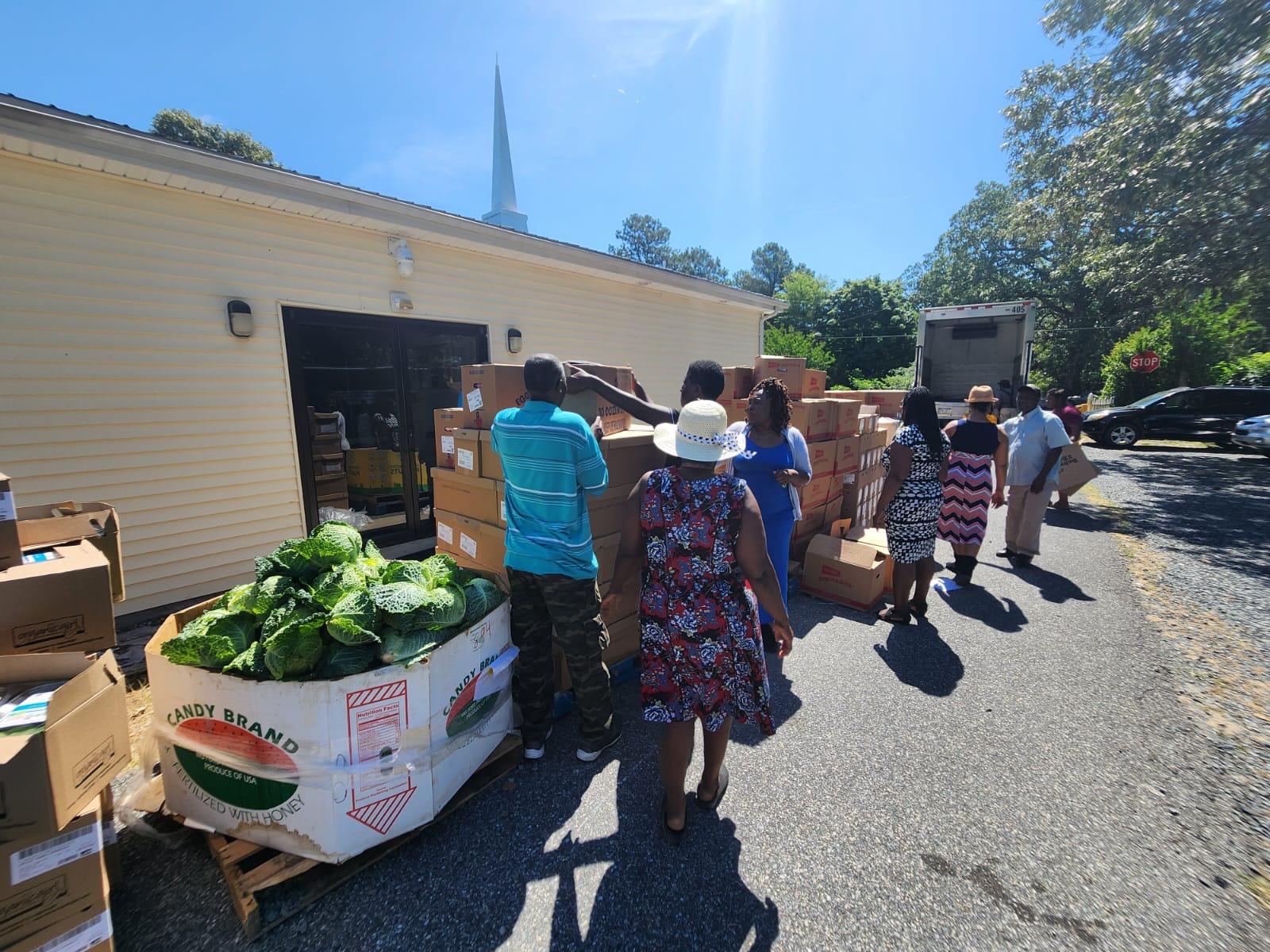 volunteers assist in preparing boxes of donation items