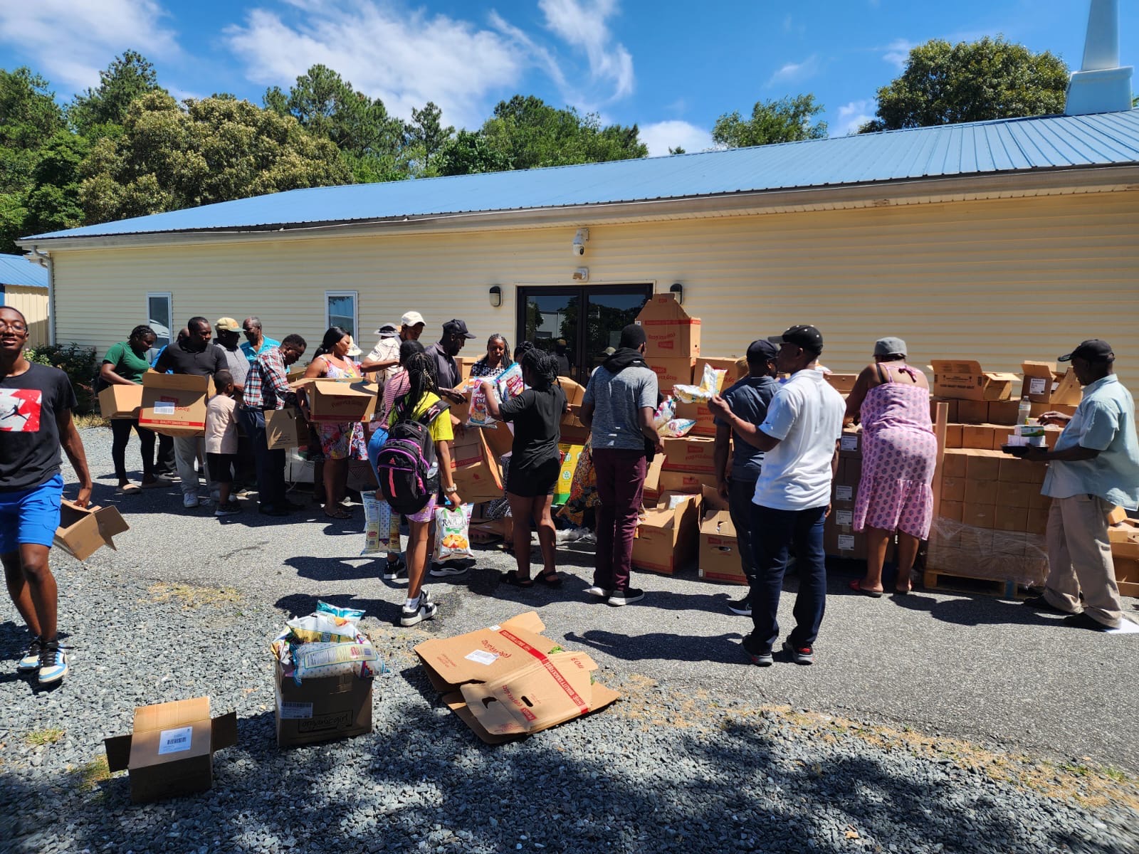 volunteers assist in preparing boxes of donation items