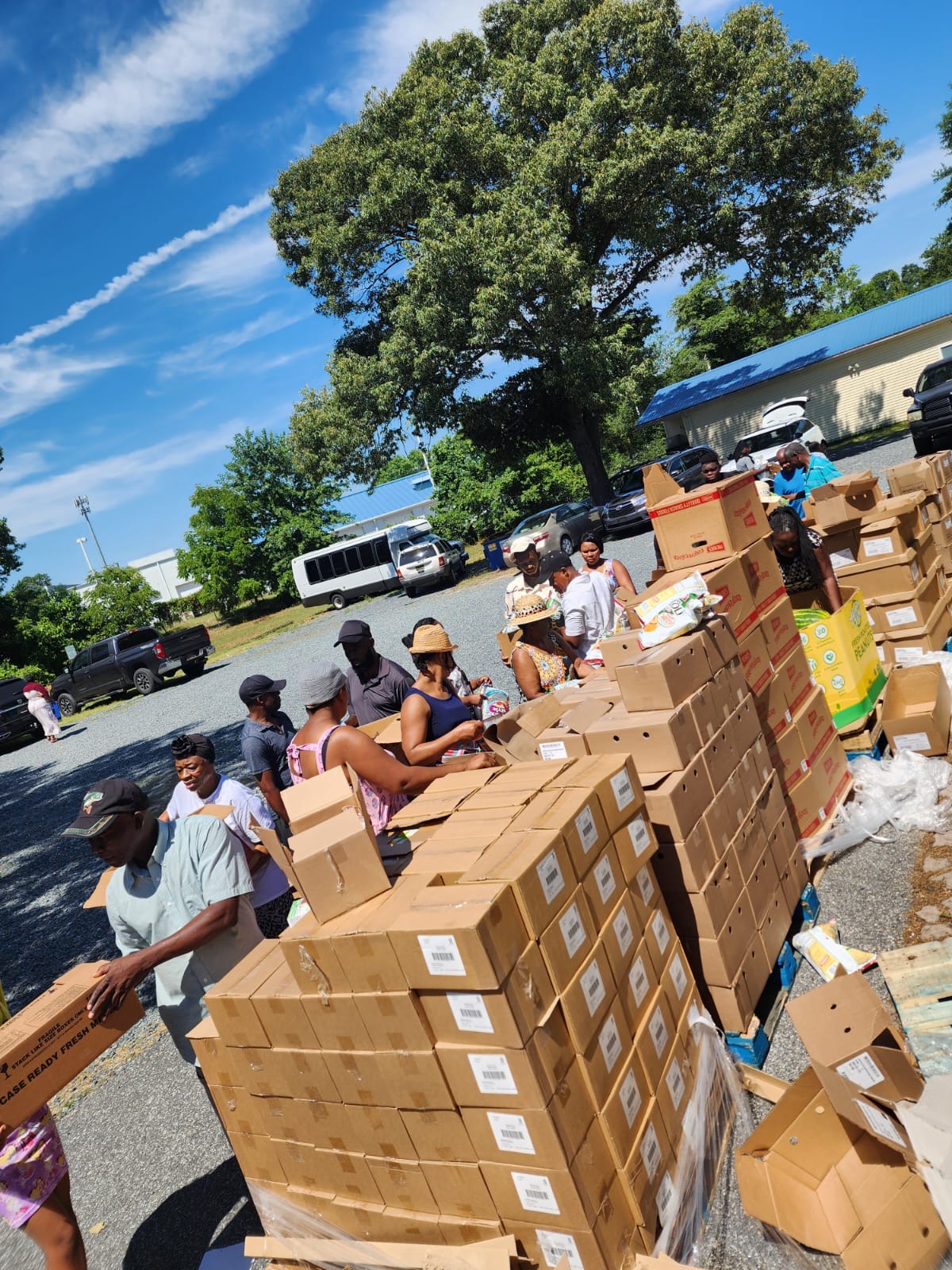 volunteers assist in preparing boxes of donation items