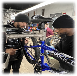 two people working on a bike