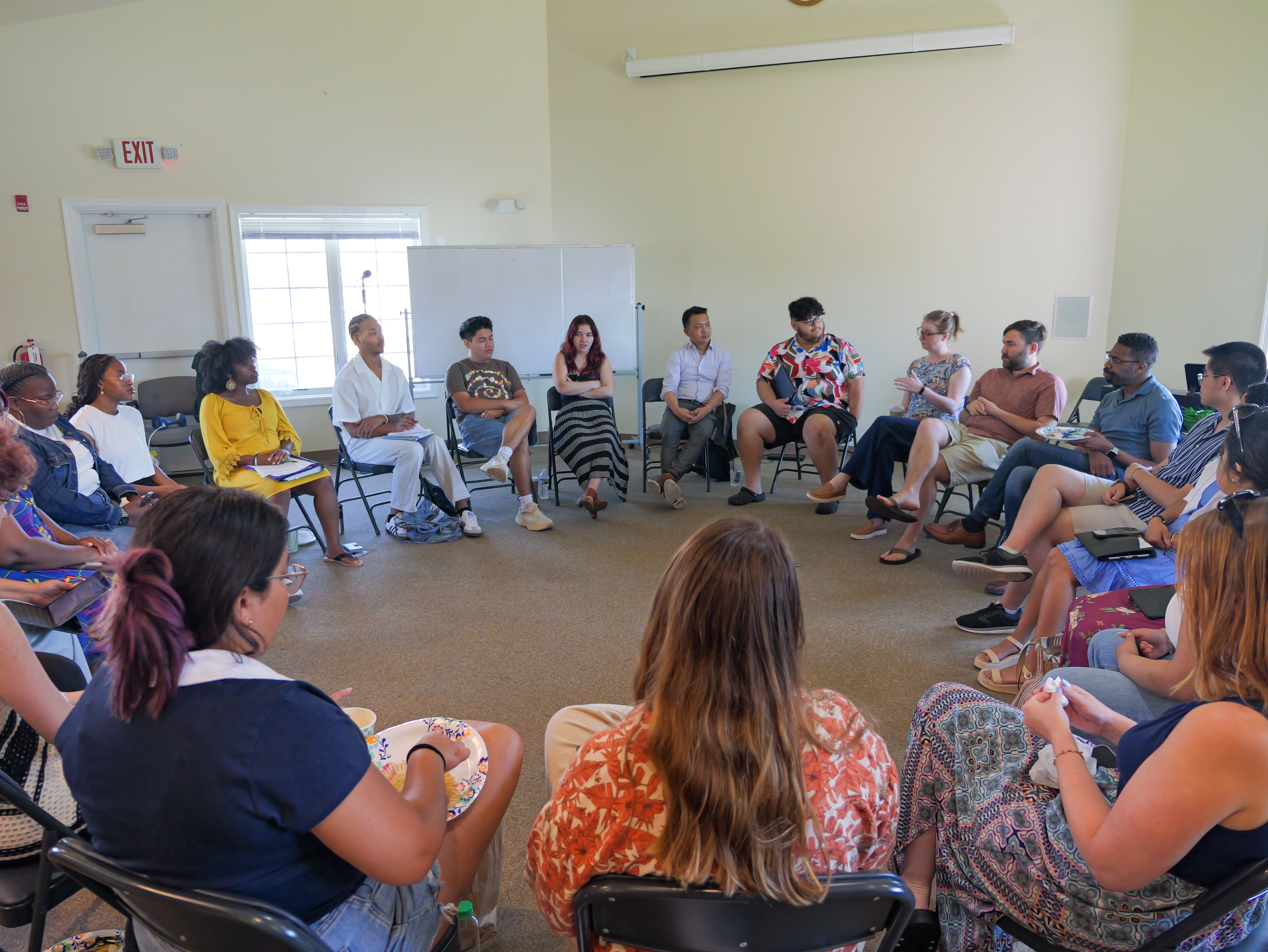 participants sitting in a circle during a music institute.