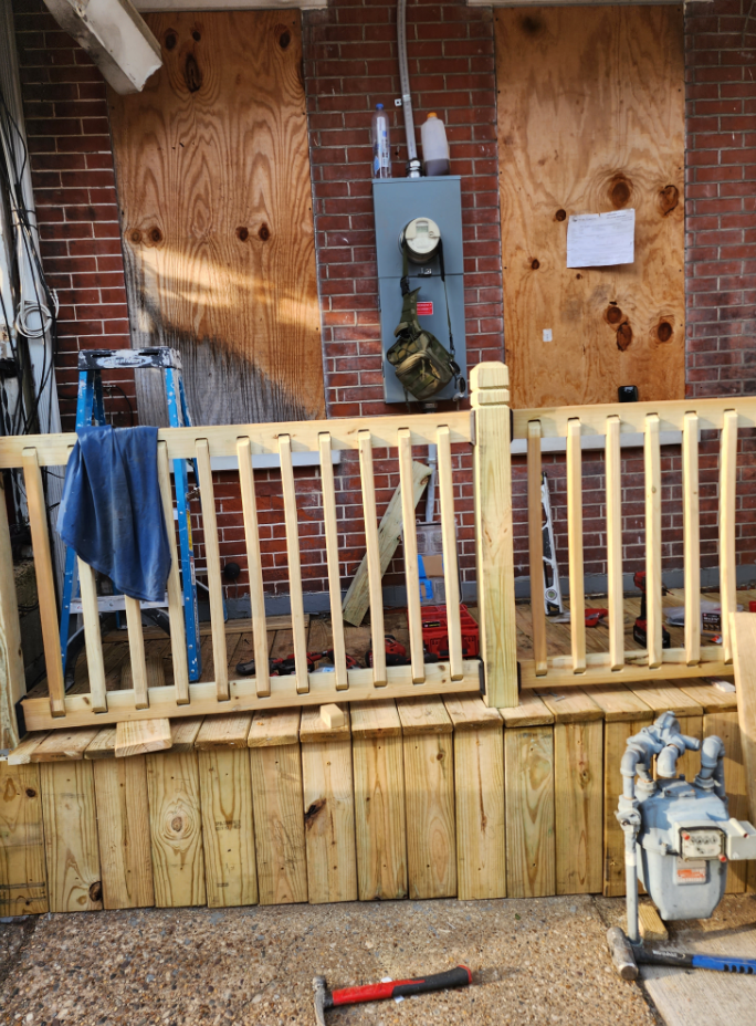 the front porch of a remodeled home with a new deck.