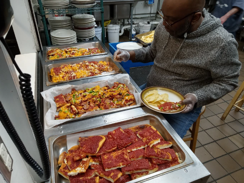 a person is packing and preparing food for a shelter program
