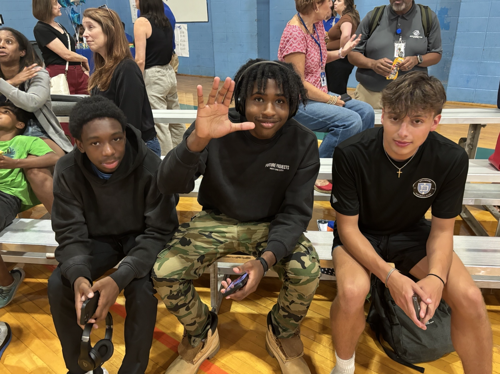 students sitting at a gym