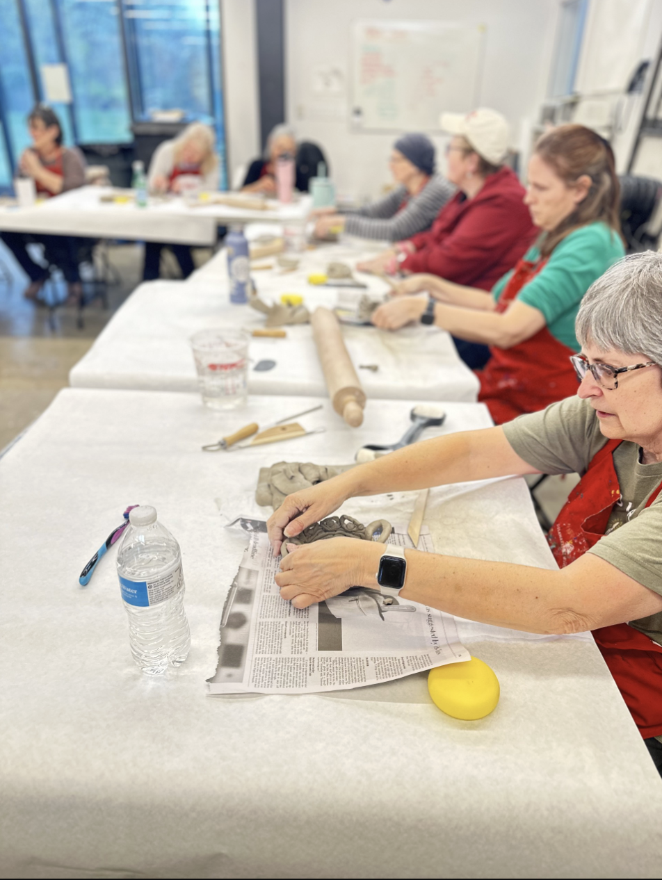 persons painting in a group workshop
