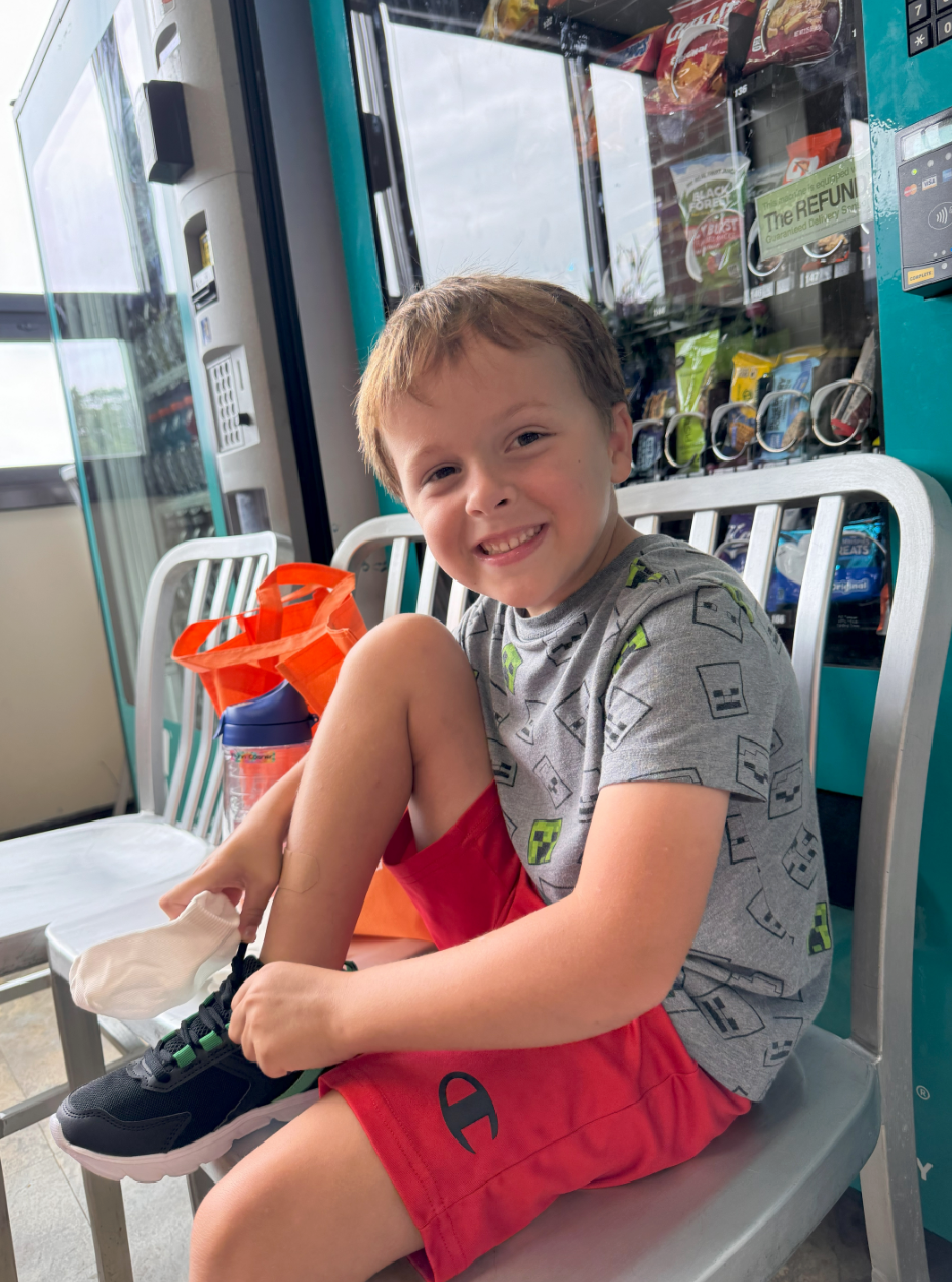 a child posing with new shoes