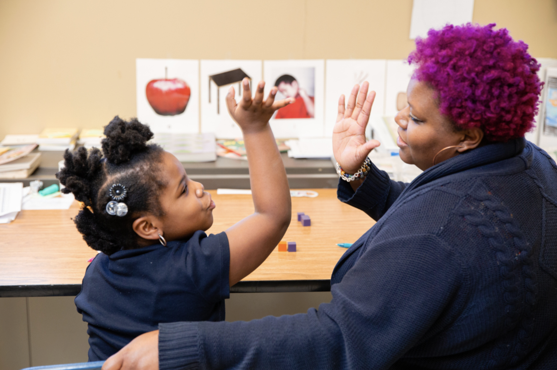student giving high five to a teacher