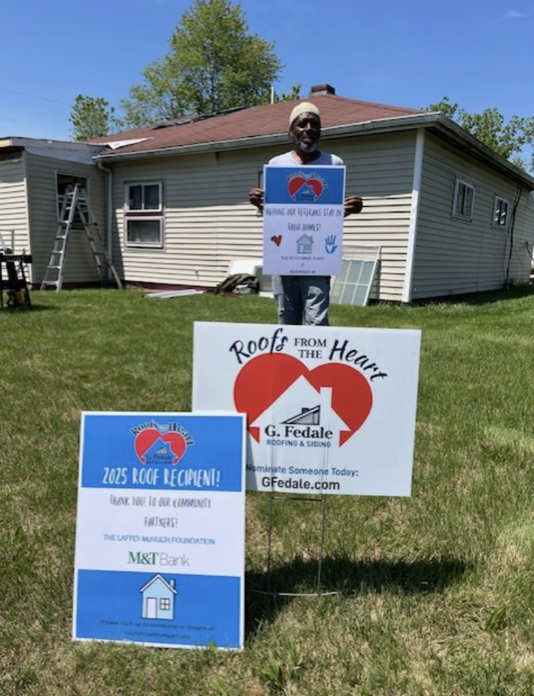 person posing in front of a remodeled roof