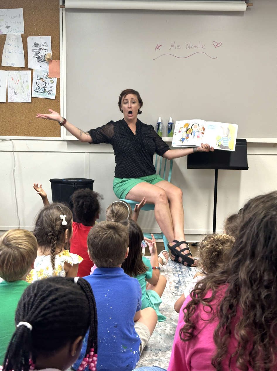 students singing with an instructor.