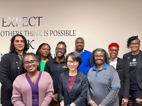 participants in a business cohort posing for a photo with instructors.