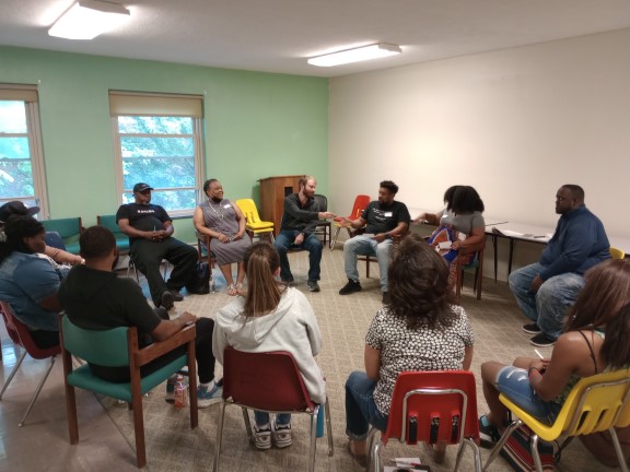 a group sitting in a restorative healing circle.