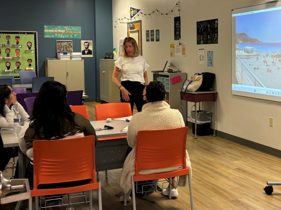 an instructor standing in a learning environment with students