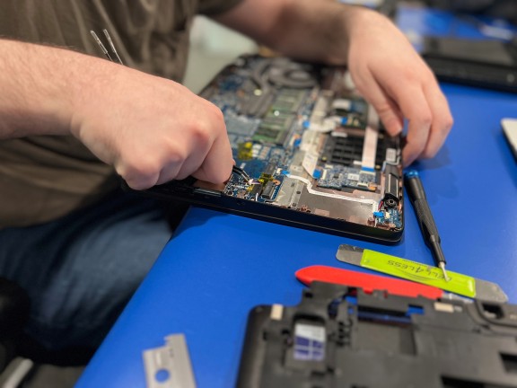 a person repairing computer technology 