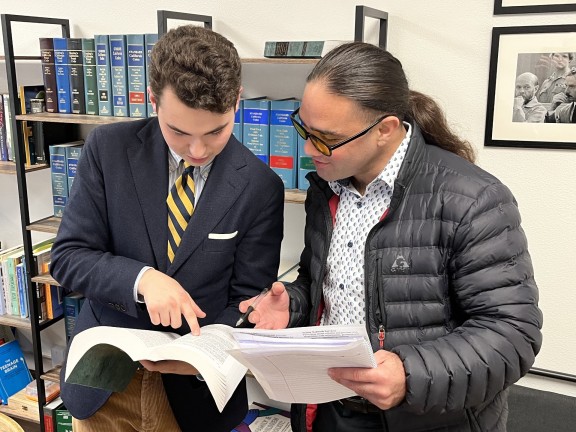 two persons reviewing legal documents.