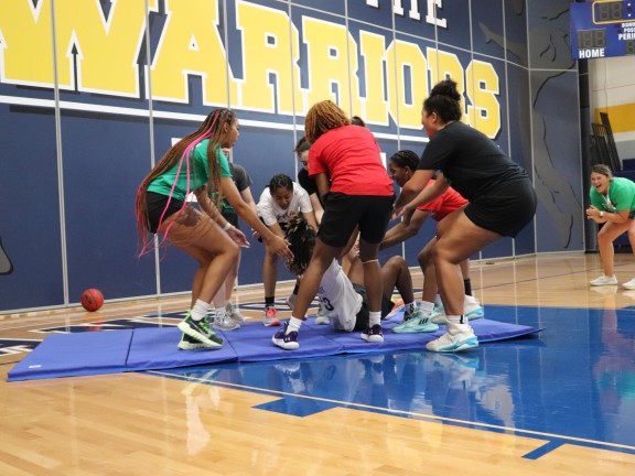 youth and counselors playing in a gymnasium sport activity