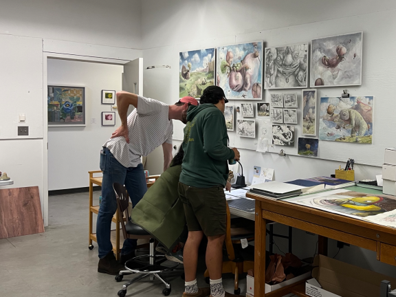 artists working in an art rooml.