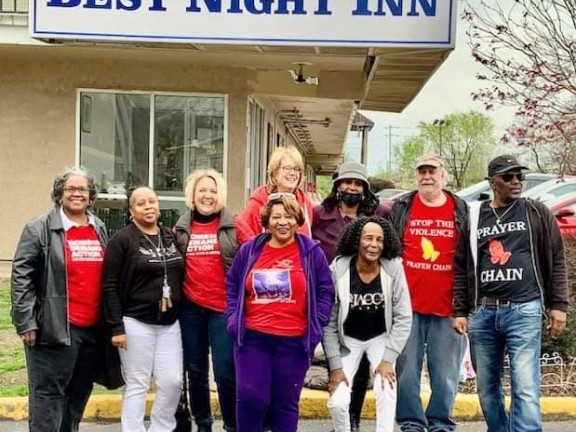 volunteers standing outside of a shelter