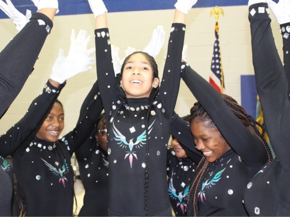 Young women participate in a dance routine.