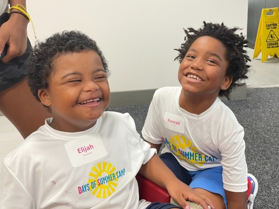 two participants in a summer program smiling for the camera.