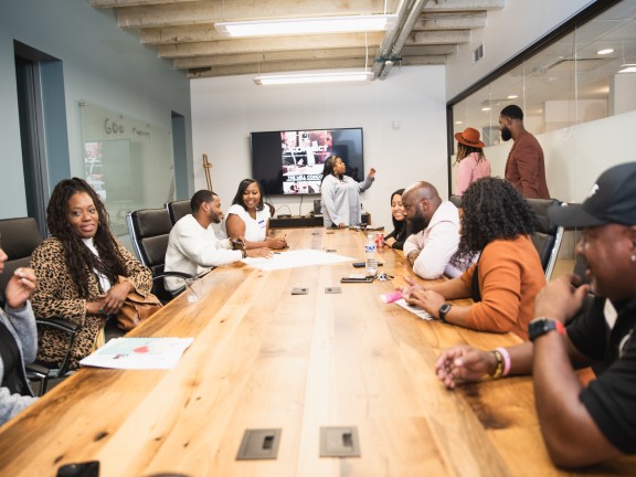 community leaders sitting at a table conducting workshops.