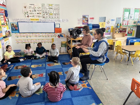 children sitting in a classroom floor