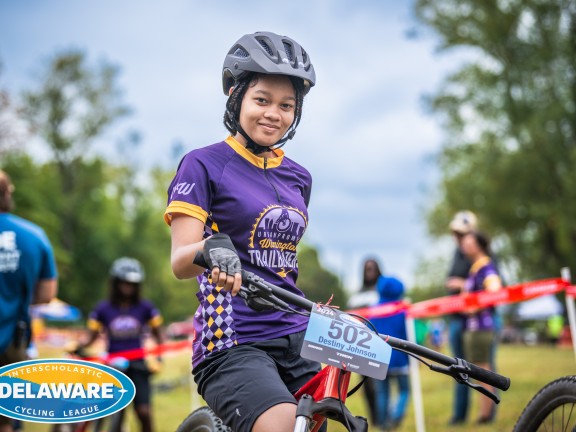 a youth participant on a bike during a bike riding competition.