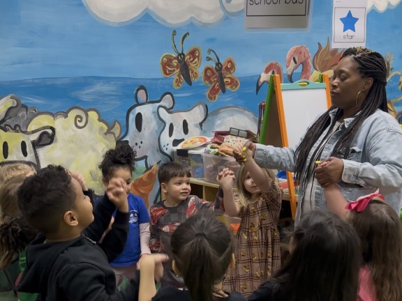 children playing and practicing mindfulness with a teacher