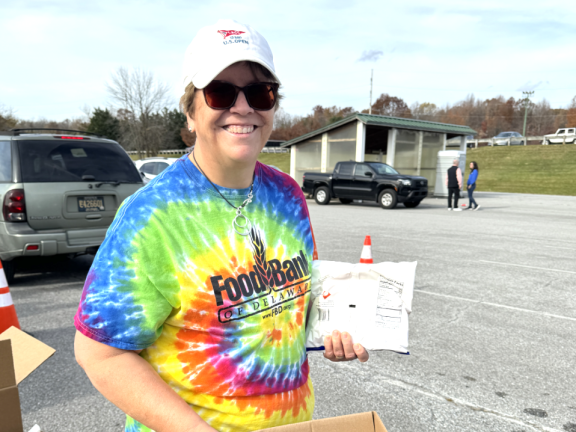 VOLUNTEER GIVING AWAY FOOD