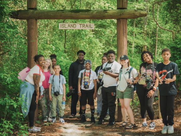 students posing with cameras on a trip