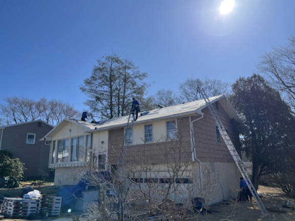 volunteers working on a house