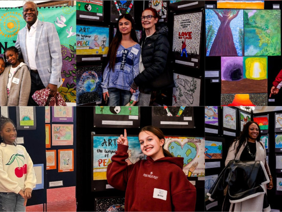 students posing with their art