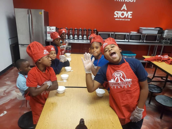 students posing in a cooking class