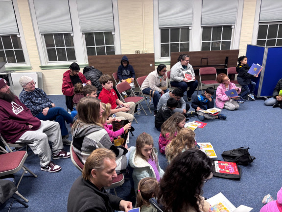 families sitting and reading books