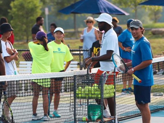 kids and instructors preparing for tennis camp