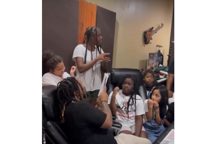 students recording music in a studio room