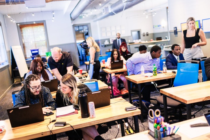 Tech Impact students sitting at desks working on computers