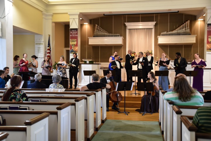 participants in a choir perform to an auditorium of people.