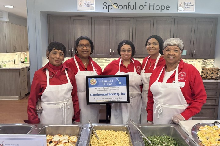 volunteers preparing food for a distribution program.