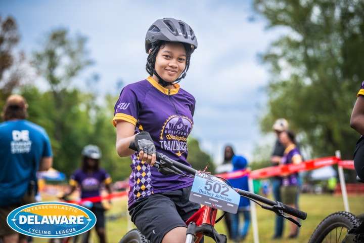 a youth participant on a bike during a bike riding competition.