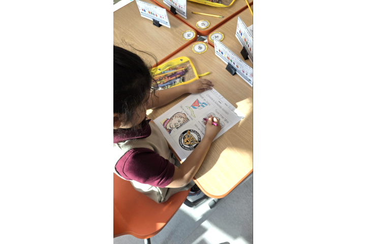 student drawing at a desk
